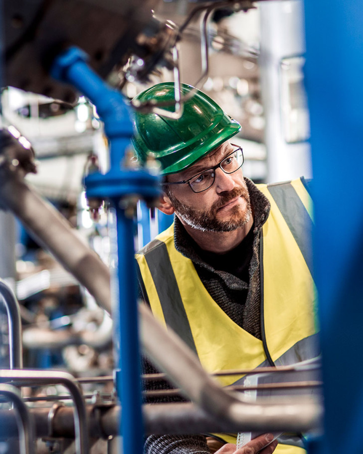 Manufacturing professional analyzing machines at factory