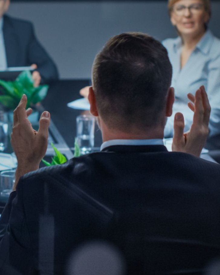 Business people sit together at a conference room having a discussion