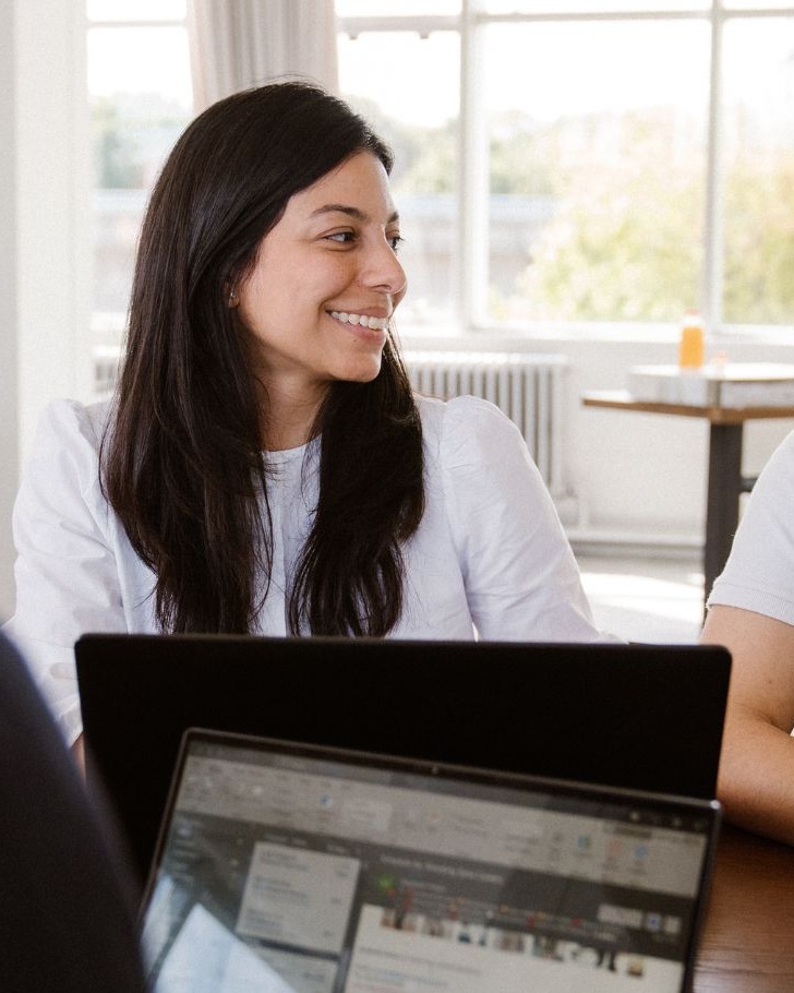 Coworkers discussing work over a meeting