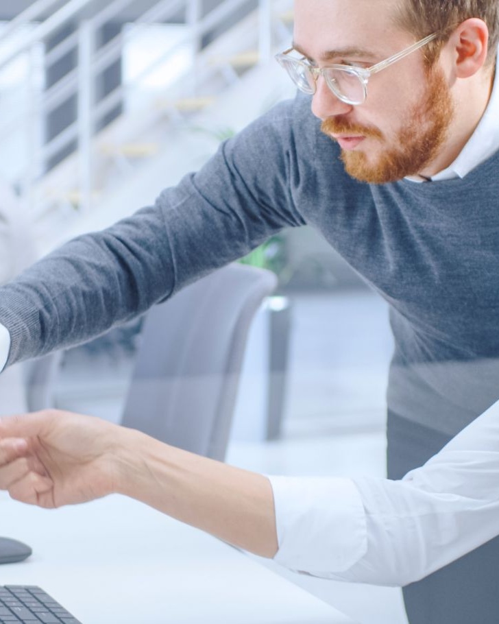 Colleagues work together on their computers