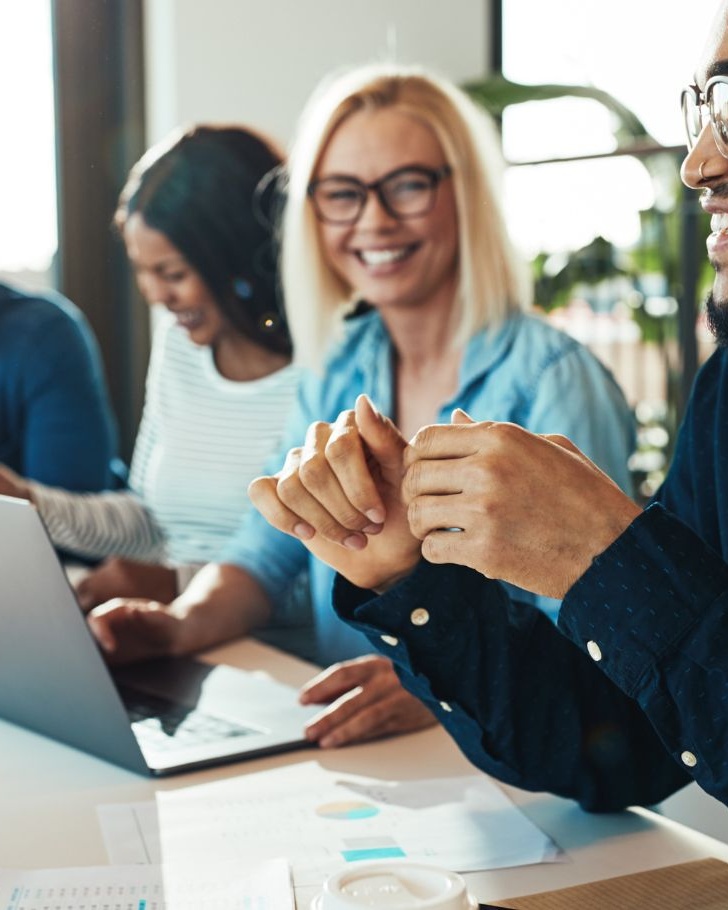 Colleagues discuss work in a meeting room