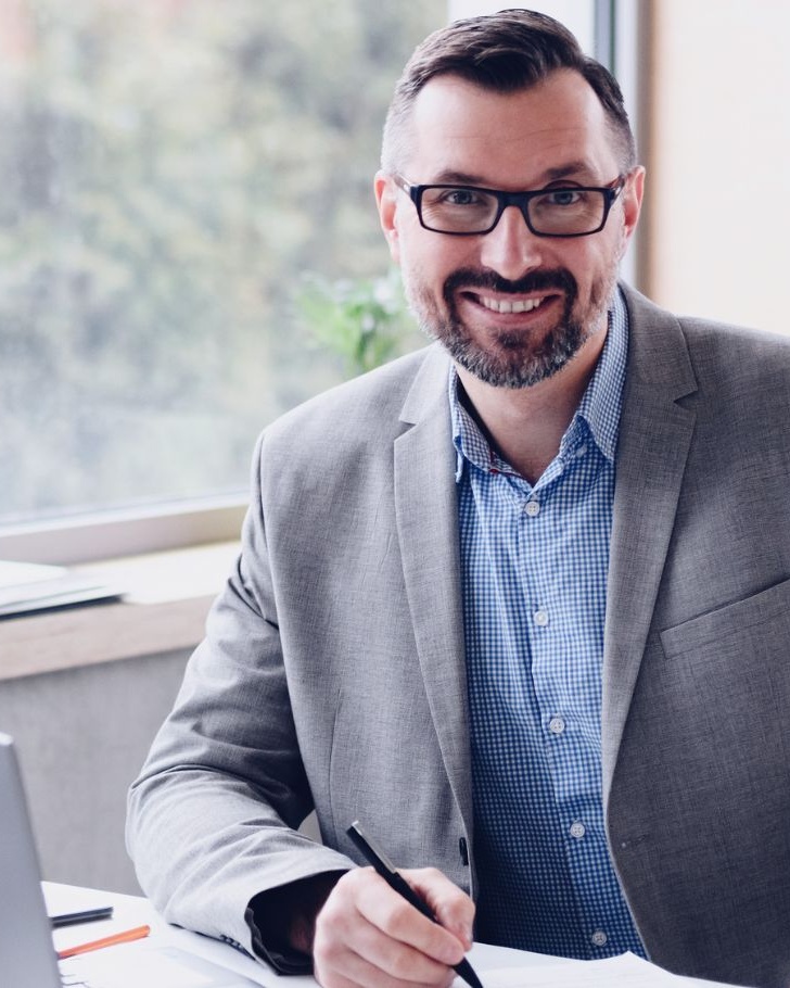 Man smiles in office