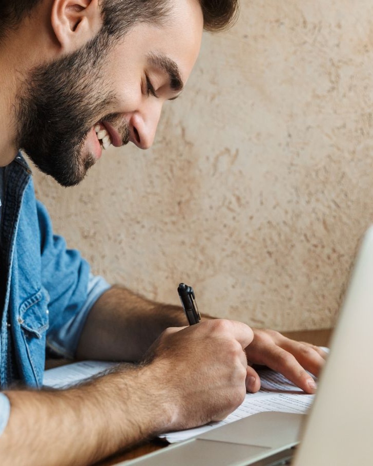 Man working on website maintenance checklist
