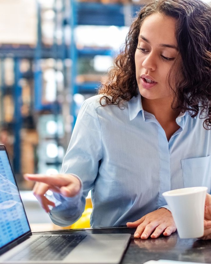 Colleagues discuss pricing strategy in a warehouse