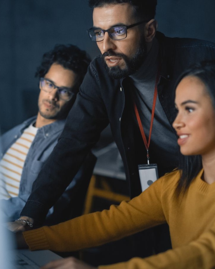coworkers look at their computer screen