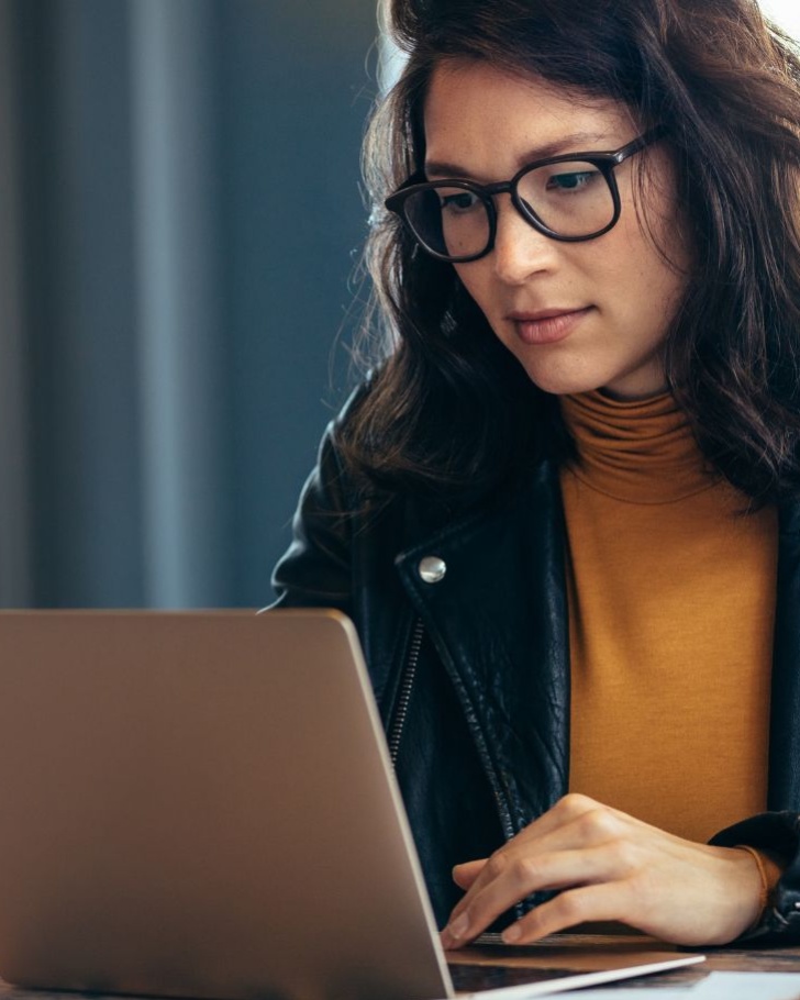 Woman works on her laptop.