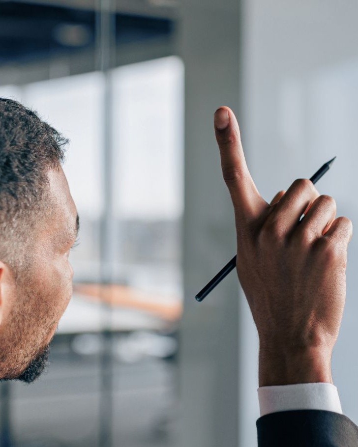 Man raises his hand in a conference room