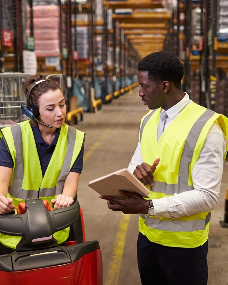 Two workers addressing supply chain issues