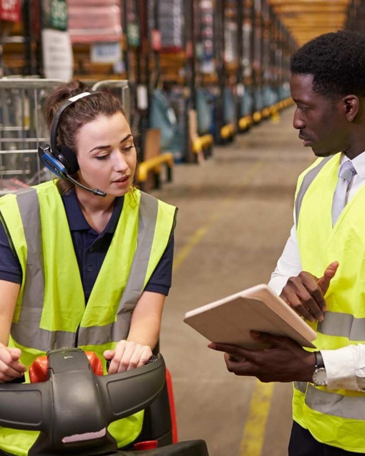 Two warehouse workers going over inventory