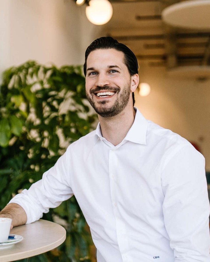 Man smiling over coffee