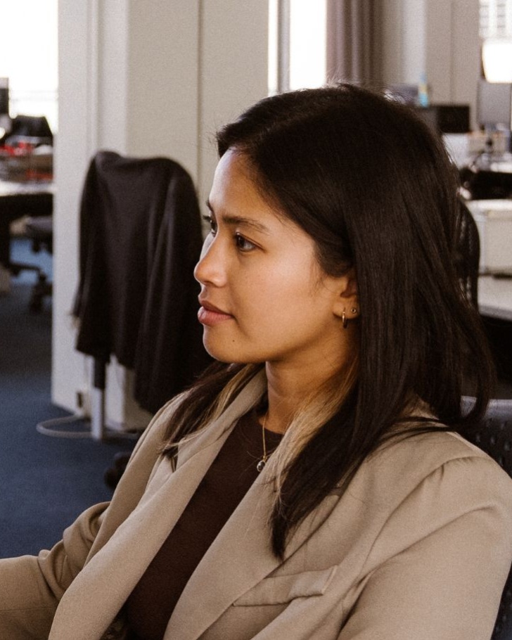 Woman working on computer with colleague