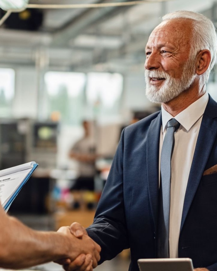 Man shaking hands with a senior colleague