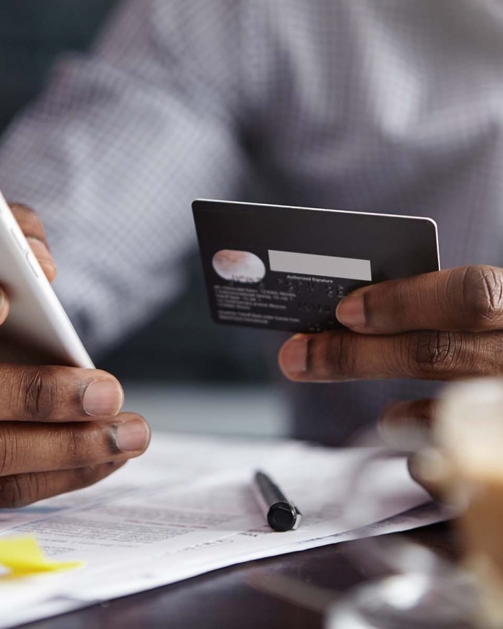 Person using credit card to shop online