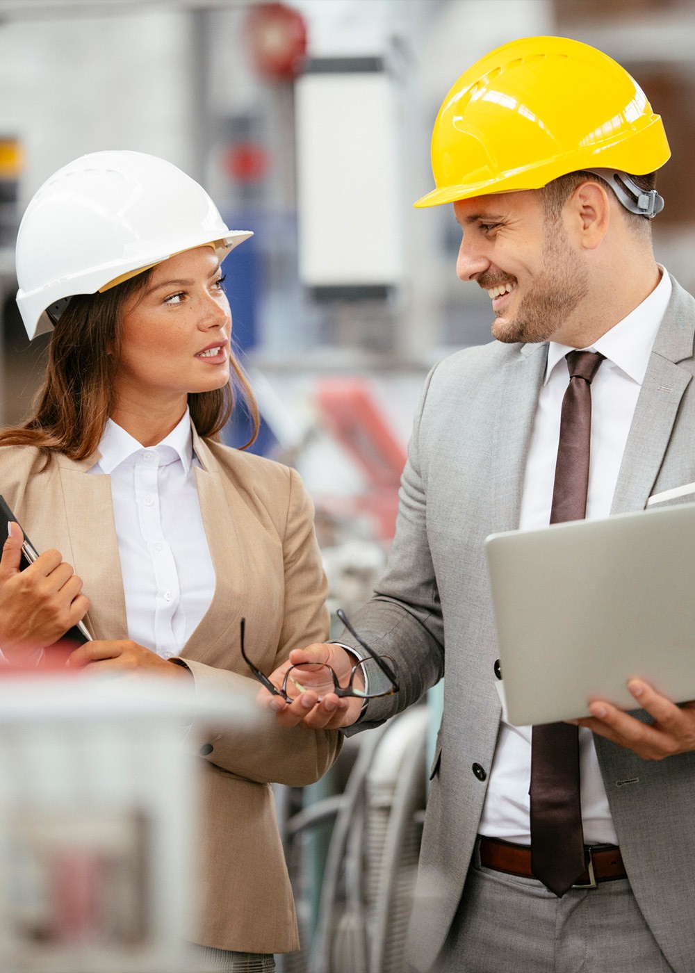 Businessman and businesswoman working in factory