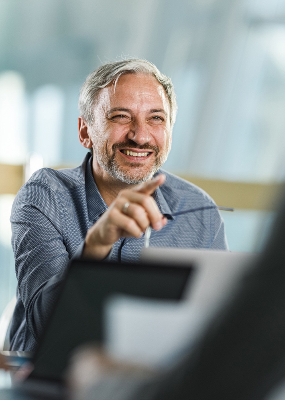 Happy businessmen talking to their colleagues on a meeting in the office