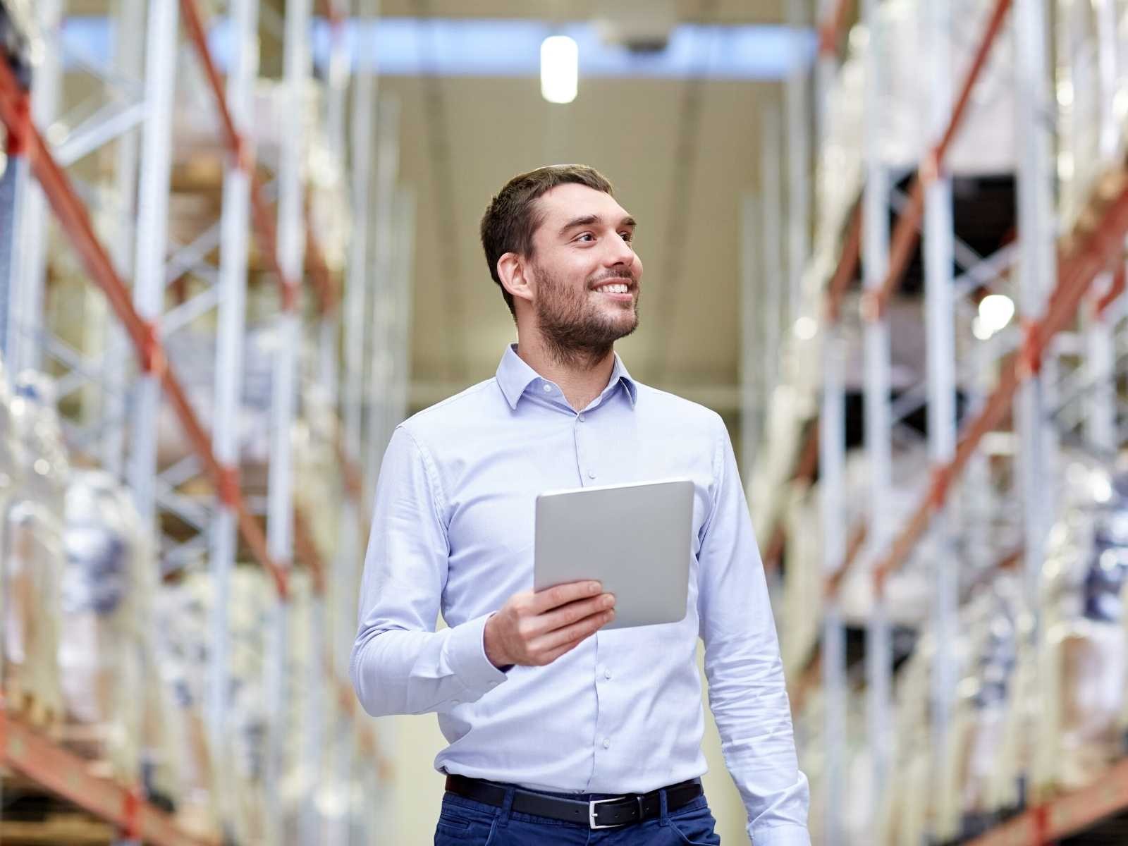 Man in warehouse working on tablet