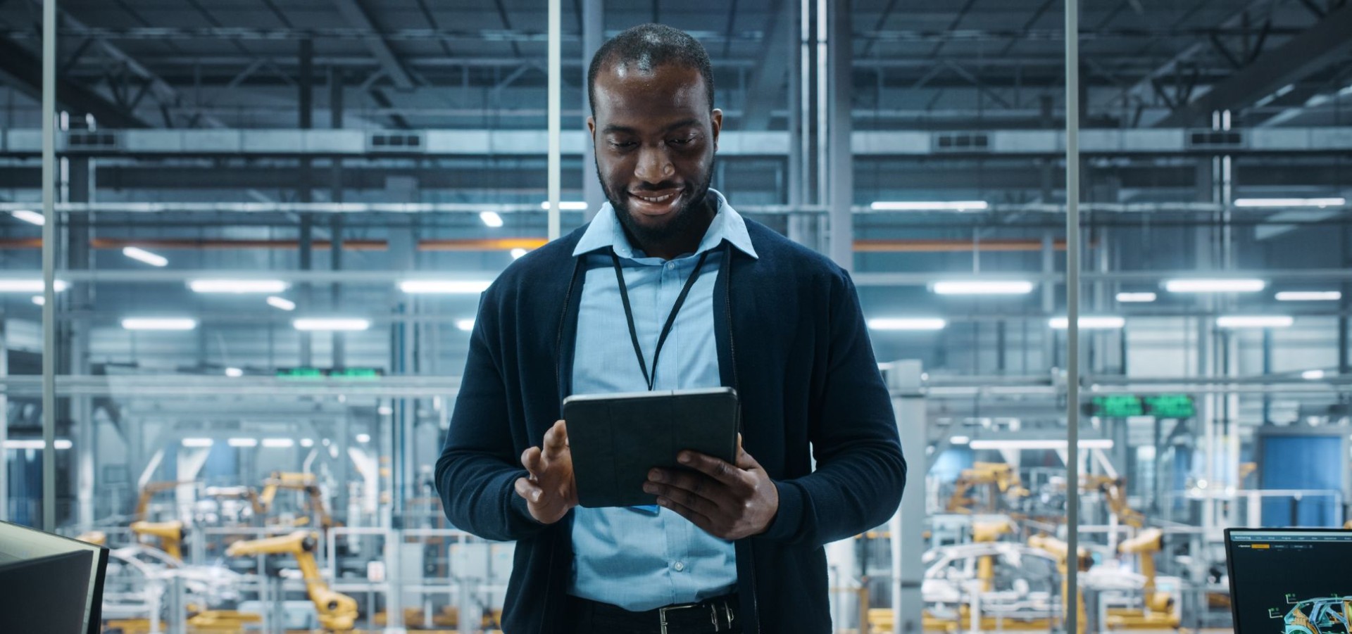 Professional in an industrial setting reviewing data on a tablet — representing the role of digital tools in an effective B2B content strategy