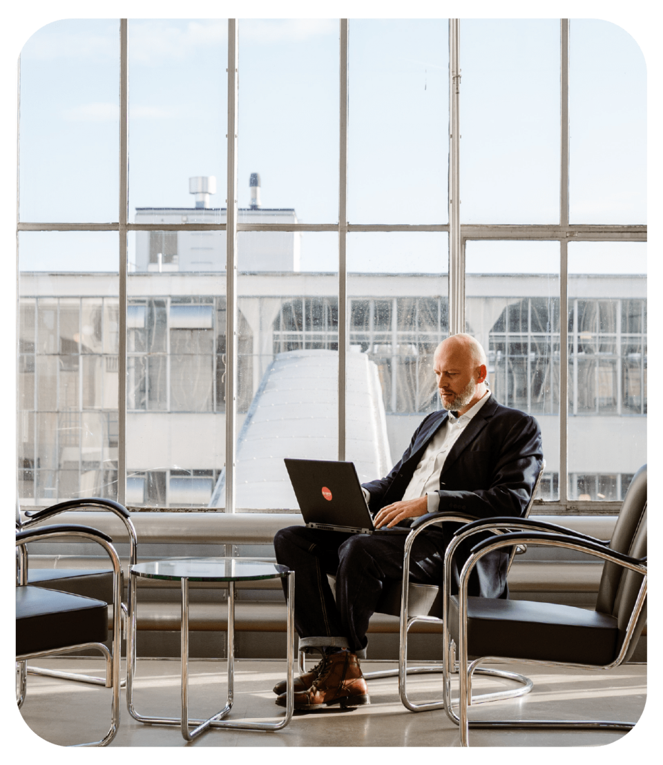 sana customer support team man siting in a chair working on a laptop