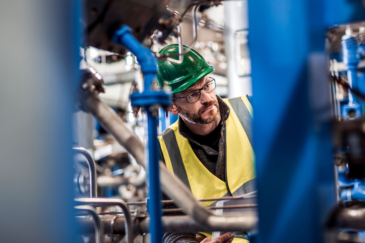 Manufacturing professional analyzing machines at factory