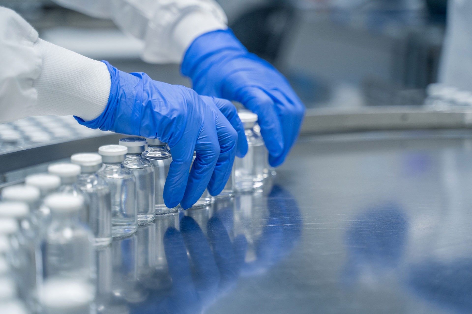Detail of hands working in pharmaceutical factory