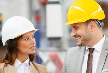 Businessman and businesswoman working in factory