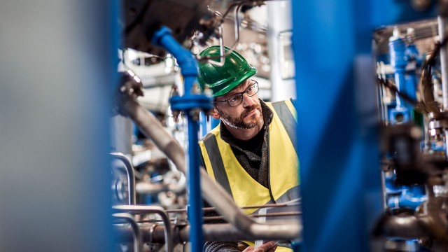 Manufacturing professional analyzing machines at factory