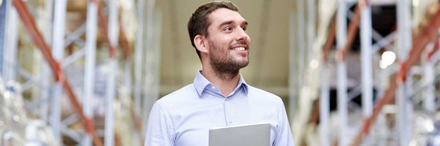 Man in warehouse working on tablet