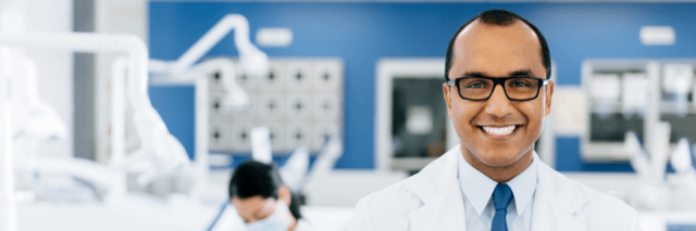 dentist standing in a room smiling