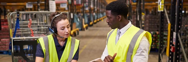 Two workers addressing supply chain issues