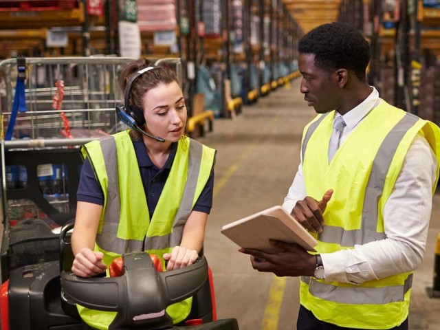 Two warehouse workers going over inventory