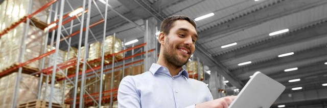 Man in warehouse working on tablet