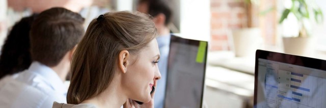 Woman-analyzing-graphs-and-figures-with-marketing-team