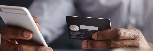 Person using credit card to shop online