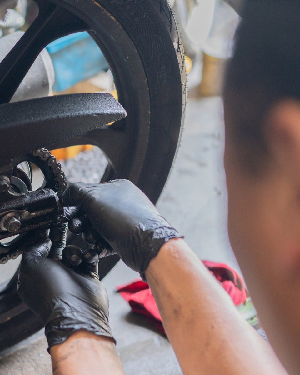 Technician at home garage replace damaged chain