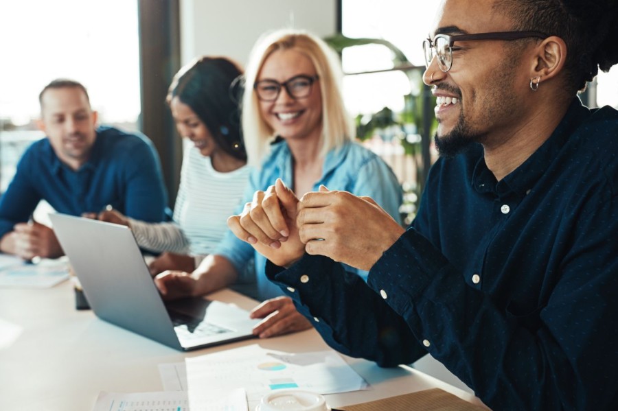 Colleagues discuss work in a meeting room