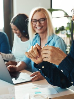 Colleagues discuss work in a meeting room