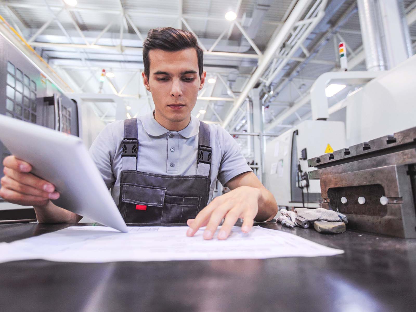 Man working with documents in a plant