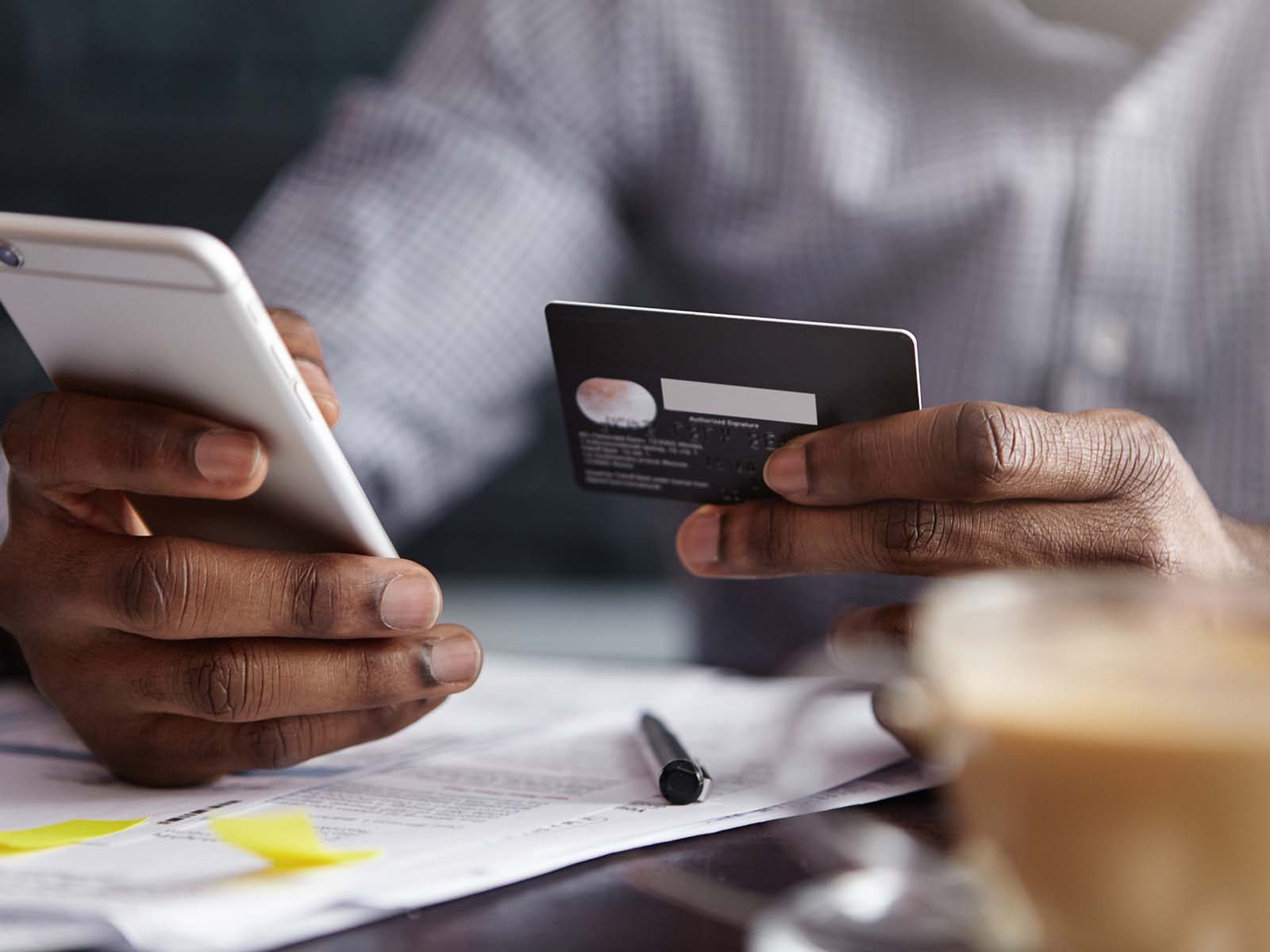 Man holding credit card and phone