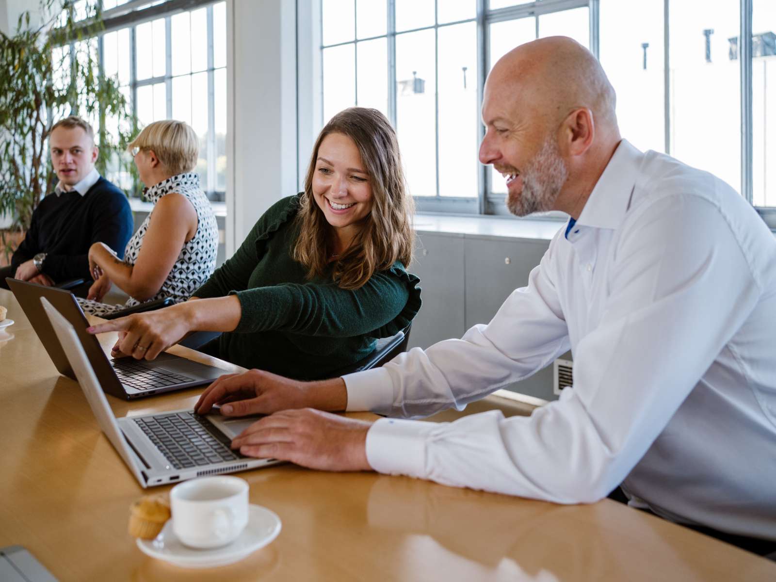 Woman and man finding mistakes in product description writing on laptop