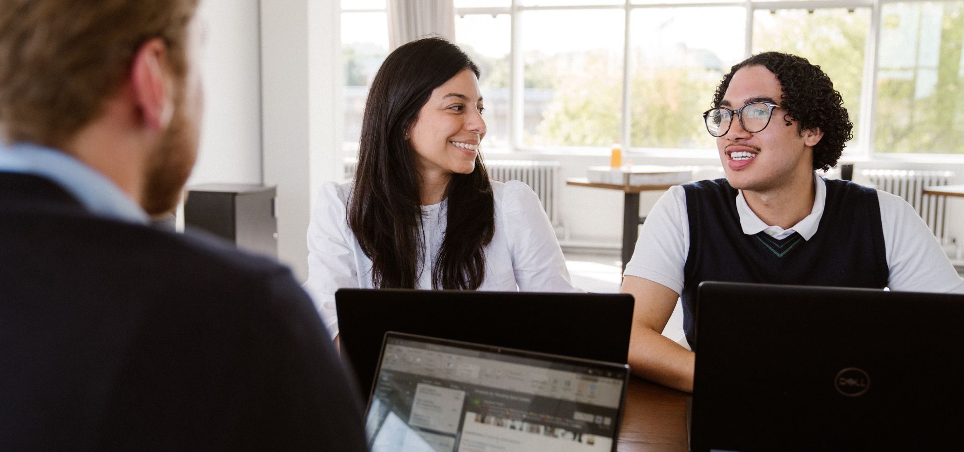 Coworkers discussing work over a meeting