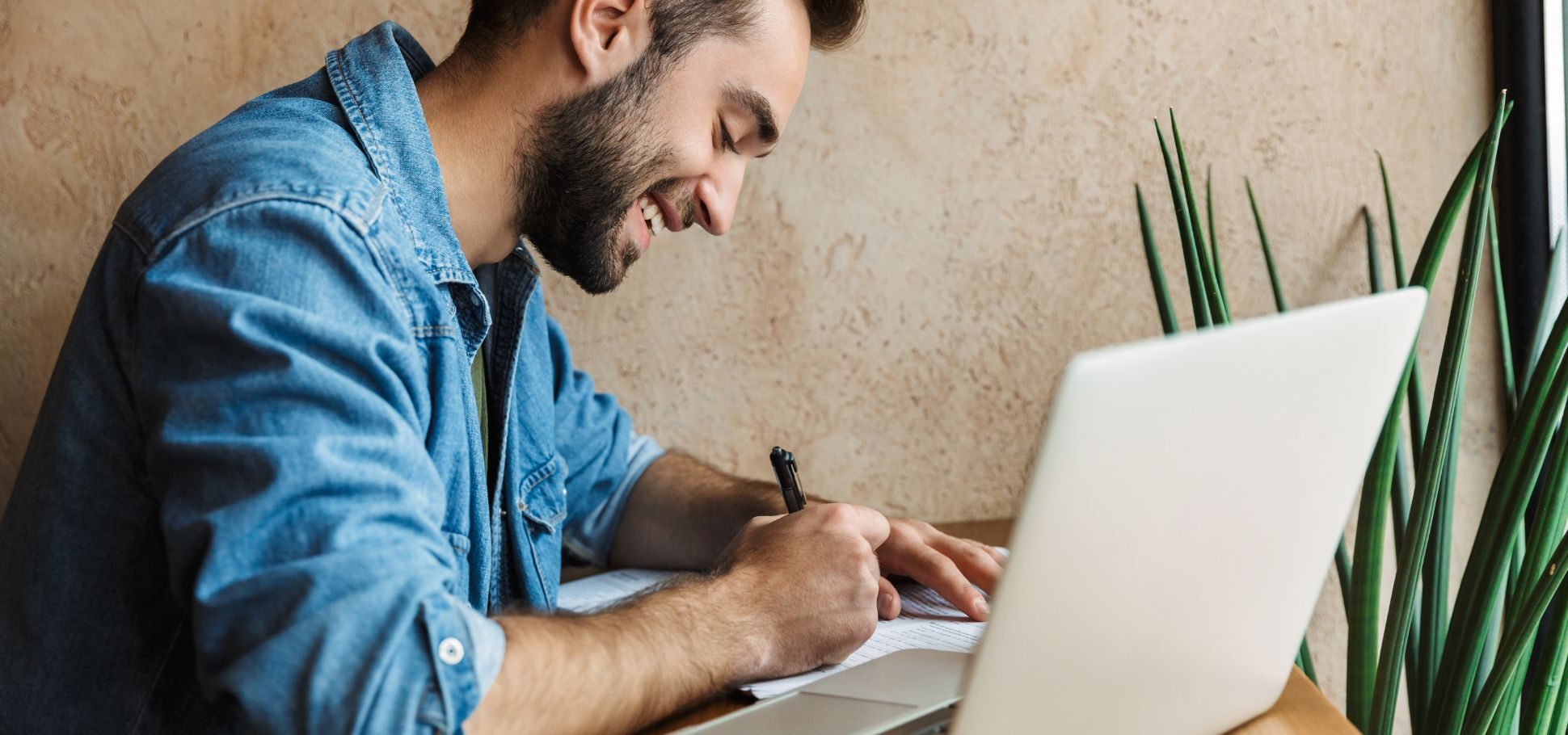 Man working on website maintenance checklist