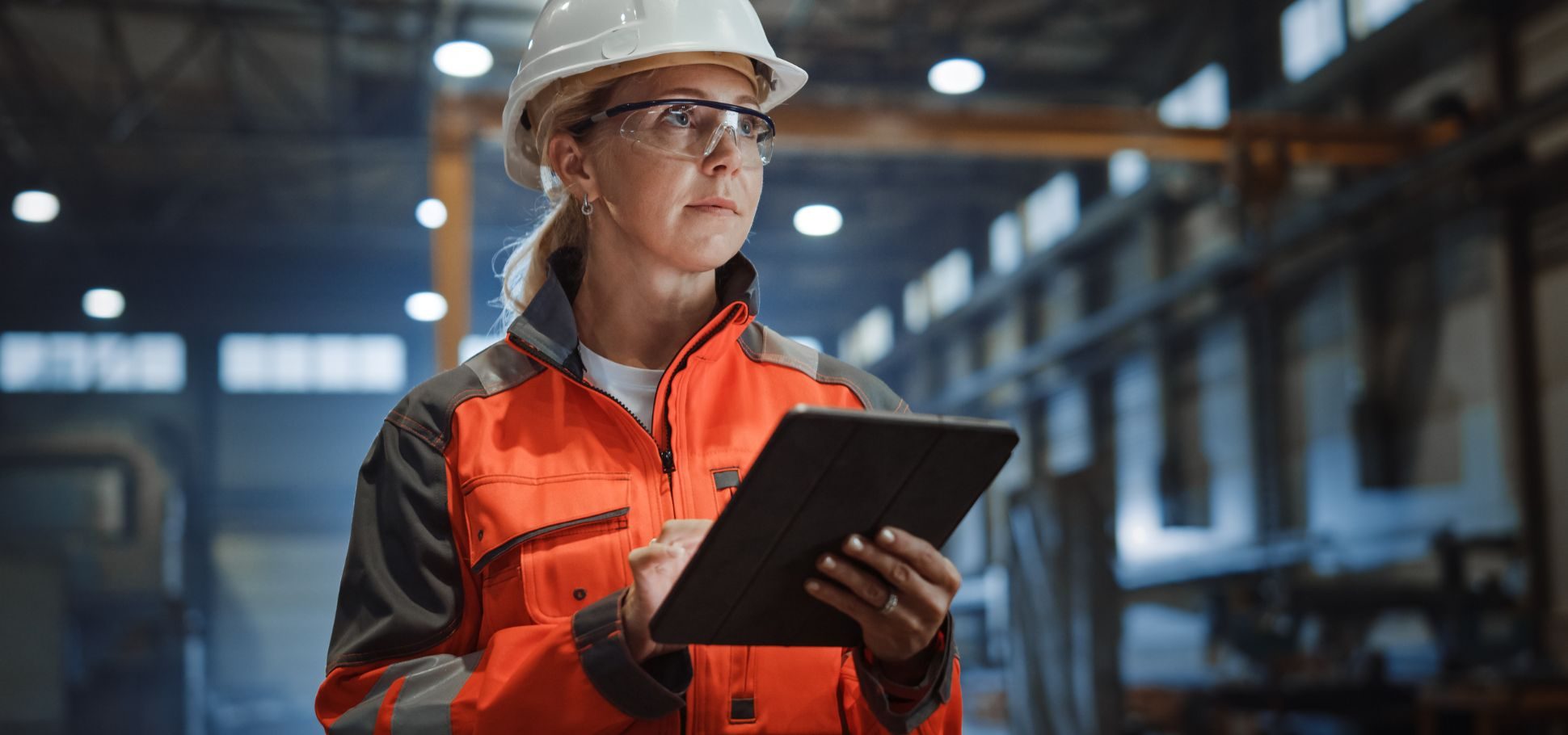 woman in warehouse managing inventory digitally