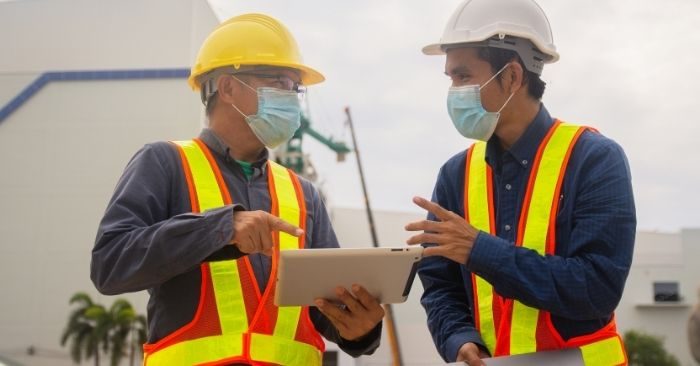 construction workers discussing work on an ipad