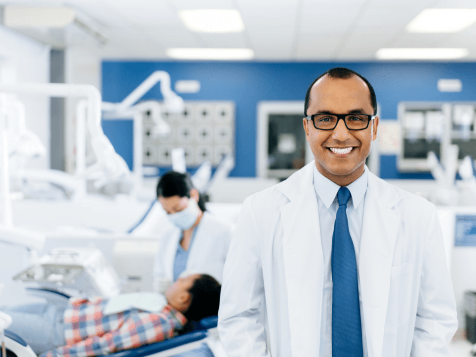 dentist standing in a room smiling