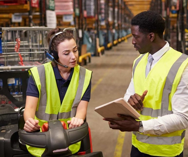 Two warehouse workers going over inventory