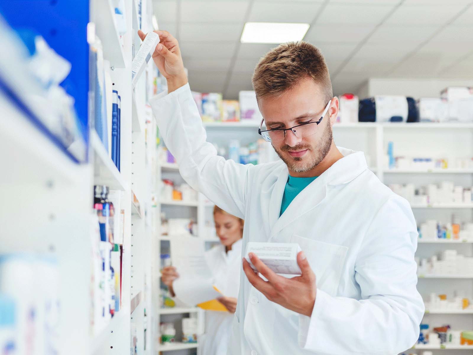 Pharmacist examining a pack of medicine
