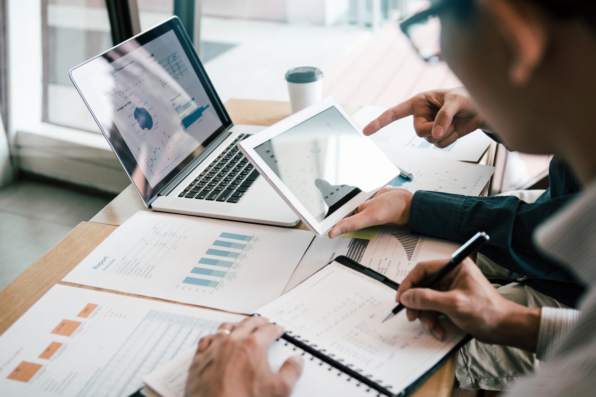 Image of two business people looking over charts and comparing notes - featured image for G2 Comparison Report
