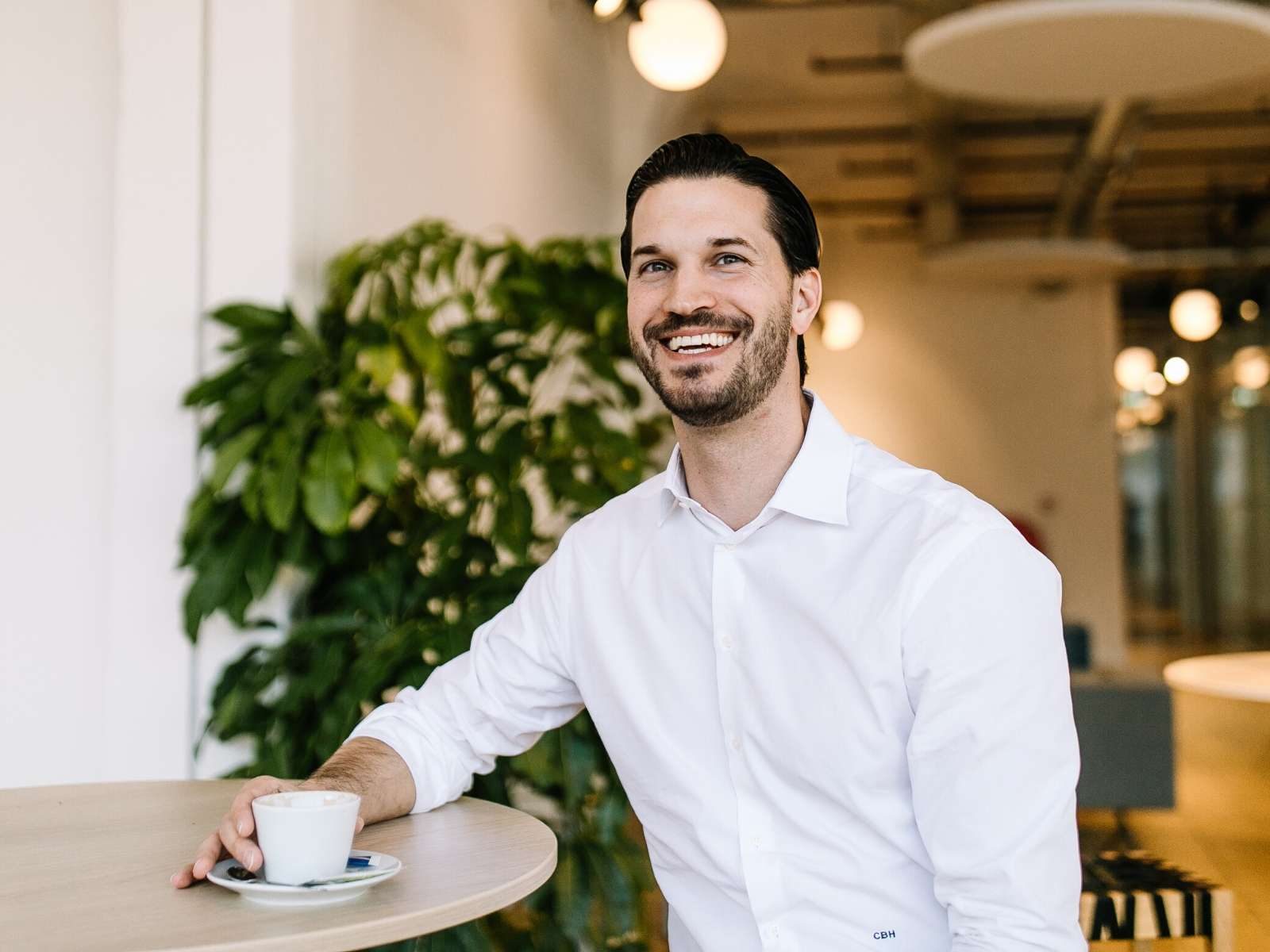 Man smiling over coffee