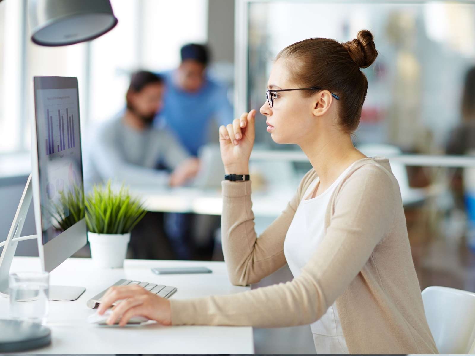 Marketer looking at marketing statistics on a computer screen