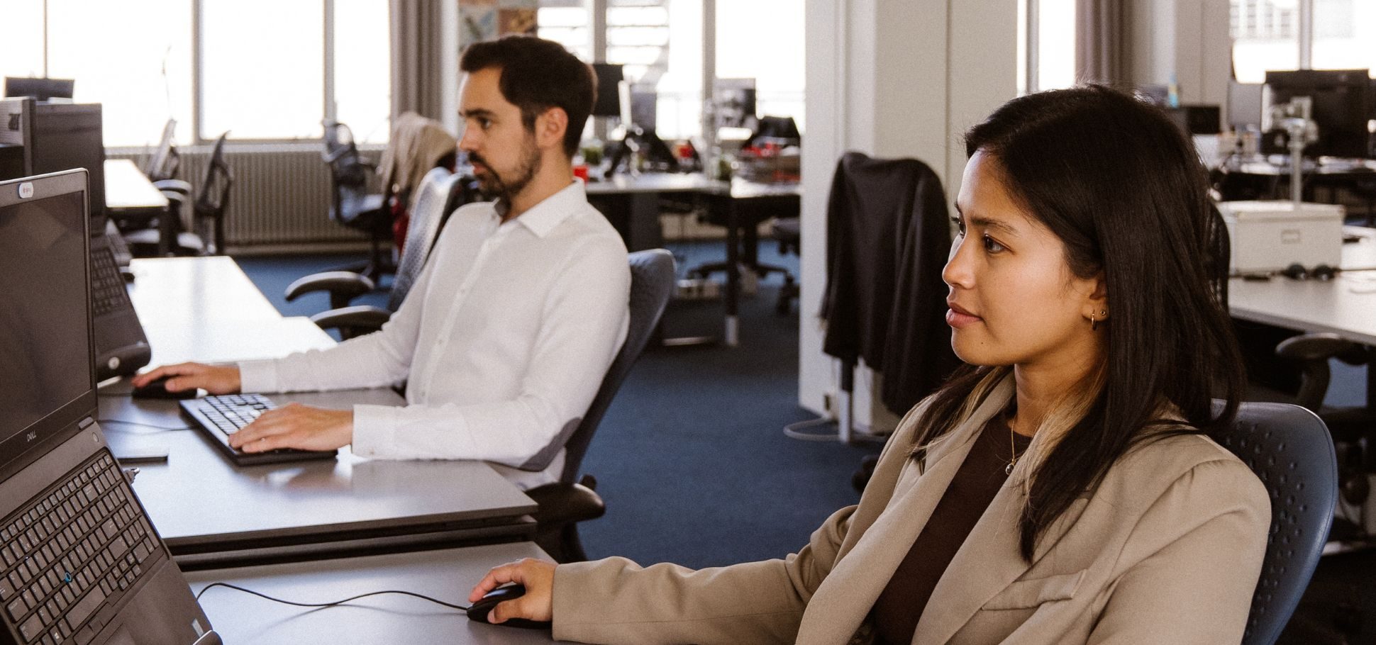 Woman working on computer with colleague